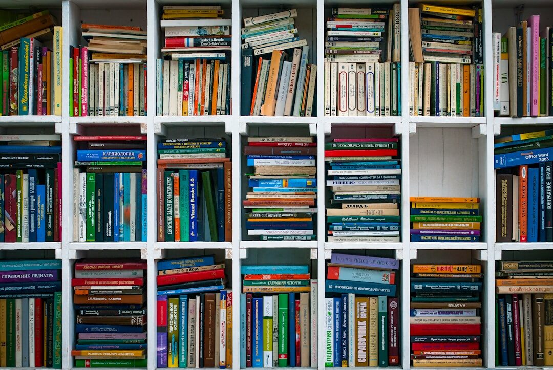Tall wooden bookshelf filled with hardcover mystery novels
